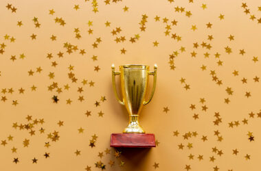 Championship award golden trophy cup with shiny stars