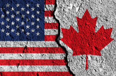 Crack between America and Canada flags. political relationship concept