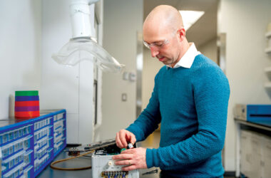 Man in safety goggles working on electrical device