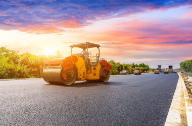 Road construction workers and road construction machinery scene
