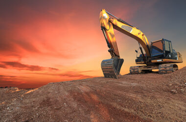 Yellow Excavators are digging the soil in the construction site