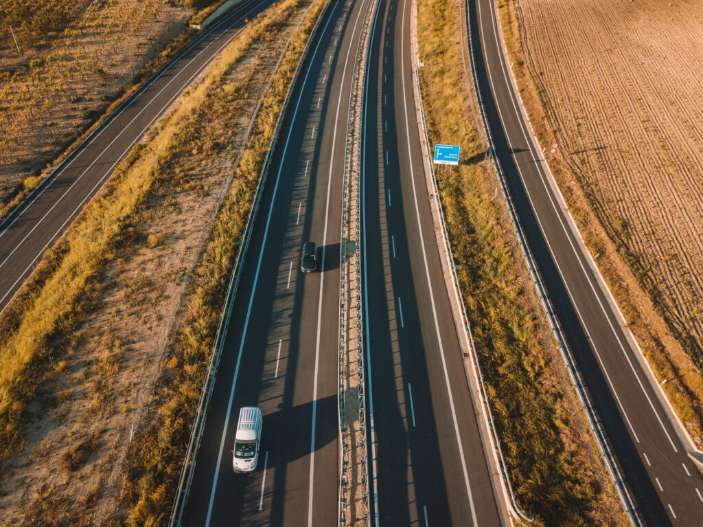 Beautiful aerial view of the highway in Italy with cars passing by.