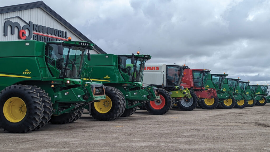 Row of heavy machinery in front of McDougal's Auctioneers facility