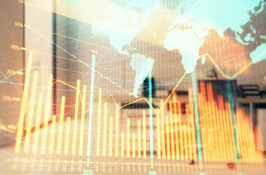 Stock and bond market graph and world map with trading desk bank office interior on background. Multi exposure. Concept of international finance