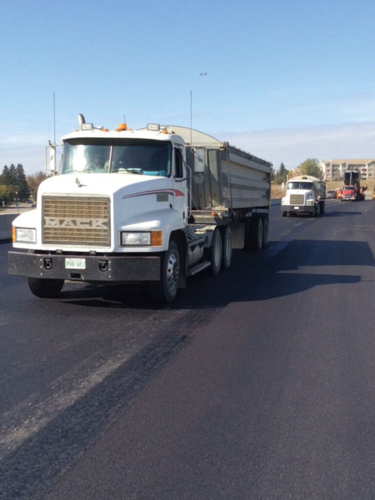 White trucks driving towards camera