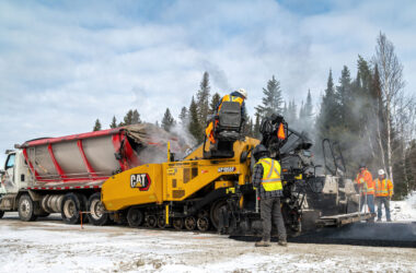 Construction crew paving road