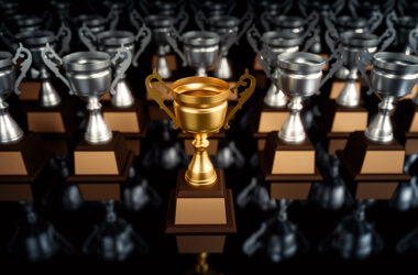 Unique champion golden trophy standing out of the crowd unique leadership business concepts.