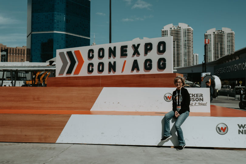 Shantel Lipp sitting on large CONEXPO-CON/AGG installation