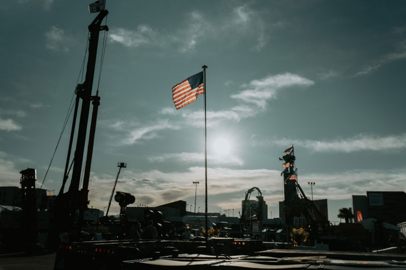 American flag with sun setting behind it, outside CONEXPO-CON/AGG 2026