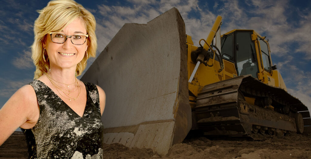 Shantel Lipp in foreground with bulldozer in background
