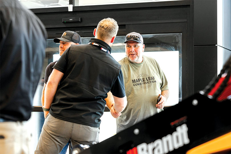 A Brandt representative greets a visitor inside one of the company’s Saskatchewan facilities