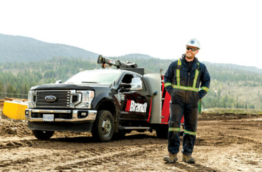 Brandt team member standing outside work truck, smiling