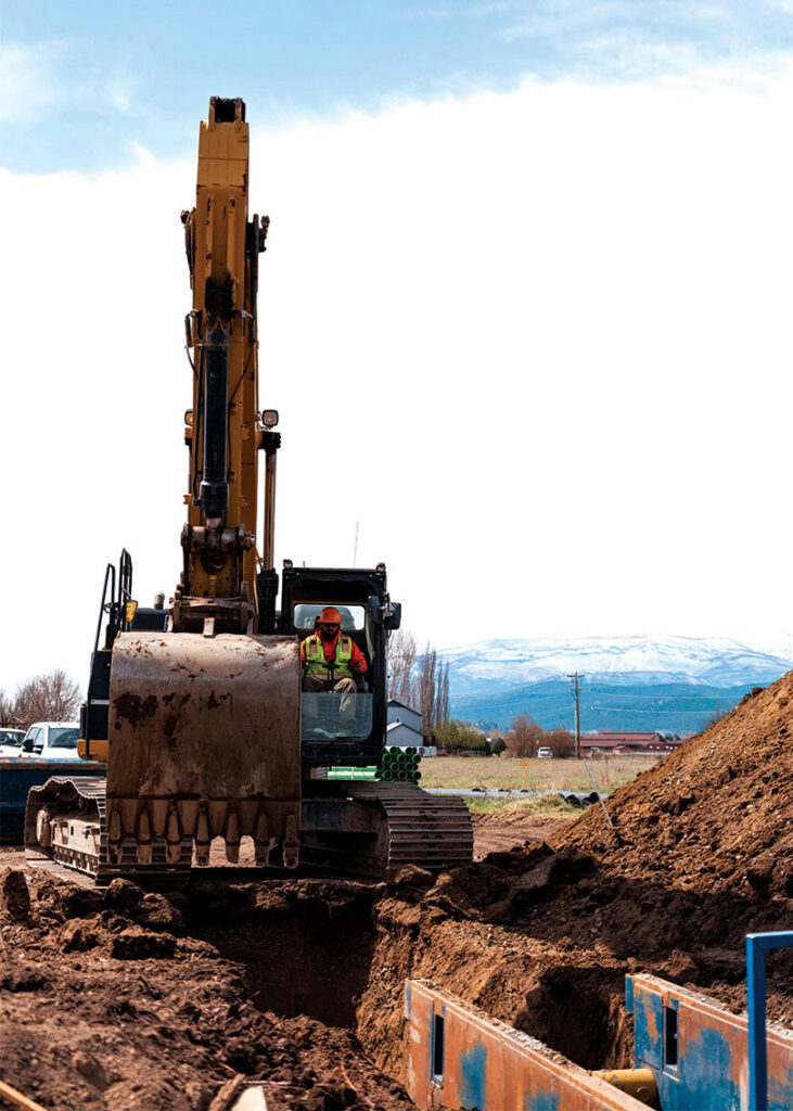 Worker operating excavator