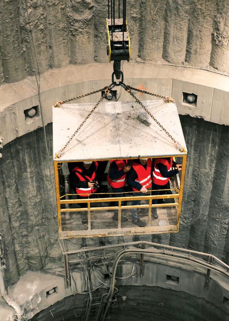 Crew being lowered or raised in construction shaft