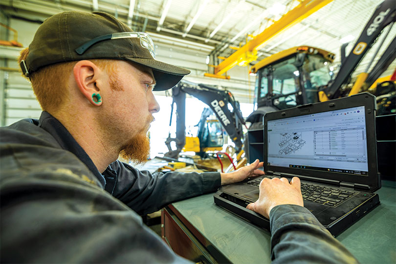A technician reviews equipment diagnostics