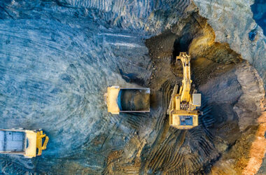 Quarry mining, work of the excavator and dump trucks, photo from the air