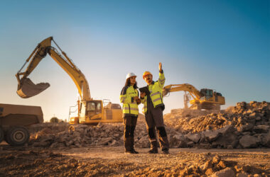 Inspector Talking to Land Development Manager With Tablet On Construction Site