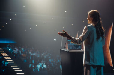 Excited Female Entrepreneur Shares an Insightful Talk at a Professional Business Conference.
