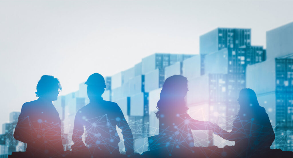 Silhouette of people with shipping containers in background