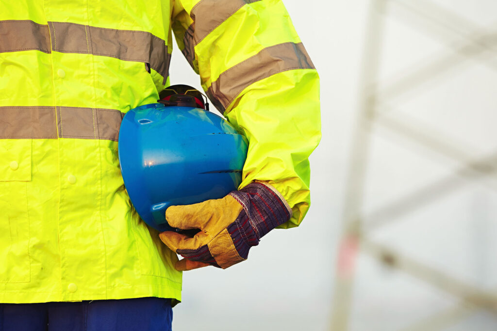 Worker holding protective helmet