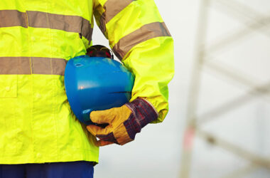 Worker holding protective helmet